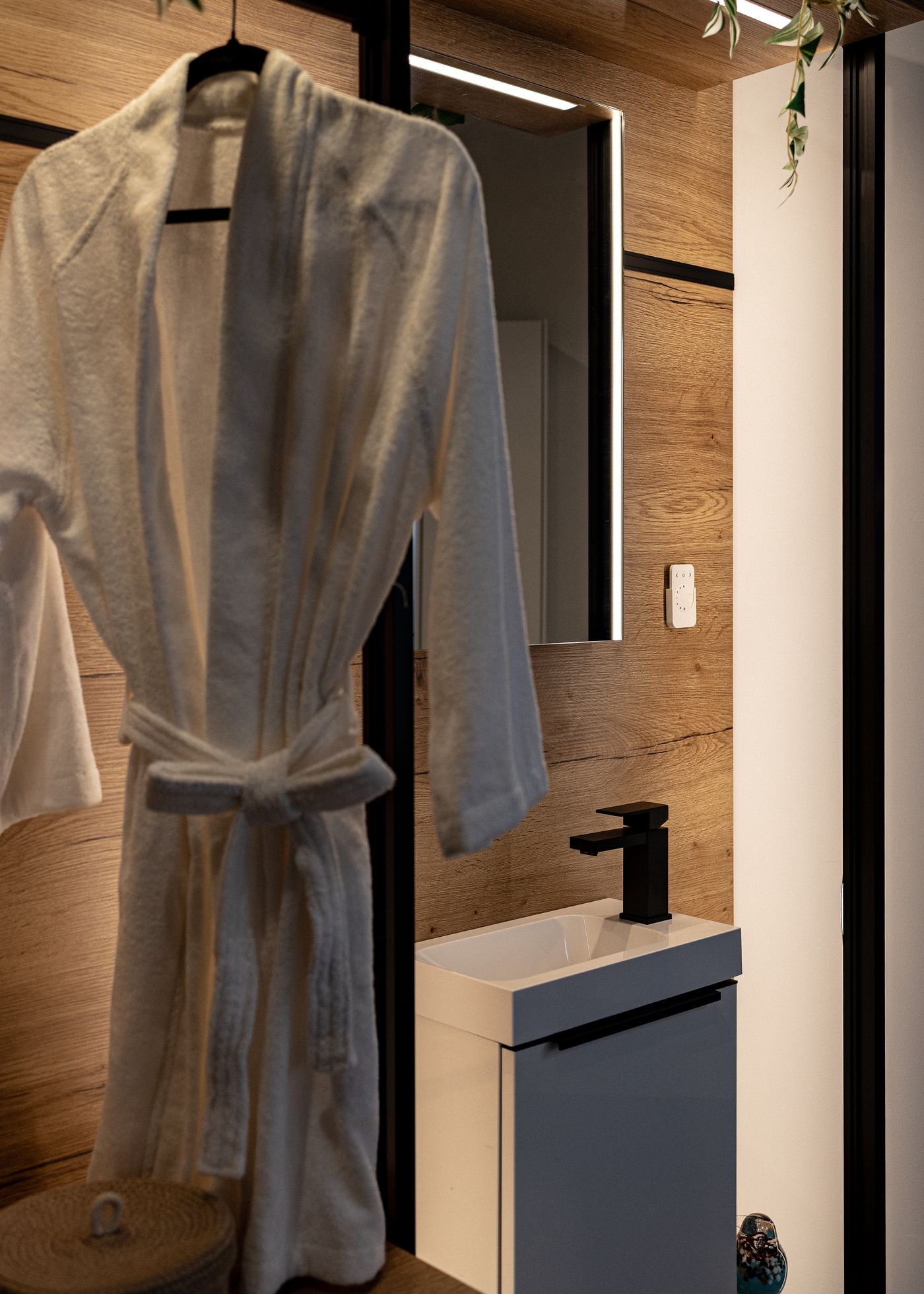 Spa bathroom with bathrobe and wood accents